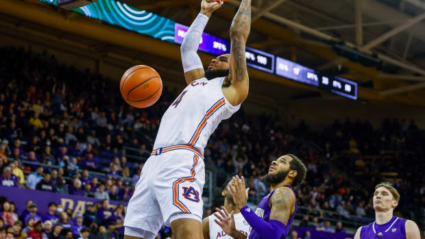Dec 21, 2022; Seattle, Washington, USA; Auburn Tigers forward Johni Broome (4, left) dunks in front of Washington Huskies guard PJ Fuller II (4, right) during the first half at Alaska Airlines Arena at Hec Edmundson Pavilion. Mandatory Credit: Joe Nicholson-USA TODAY Sports